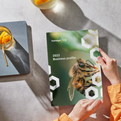 Honeycomb Health business profile booklet featuring botanical imagery and hexagon branding system.